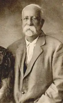 Sepia photograph of an elderly man, with whiskers