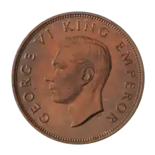 A proof penny featuring the head of King George VI circled by the text "GEORGE VI KING EMPEROR"