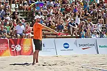 Image 6A linesman signals that a ball is "in" (from Beach volleyball)