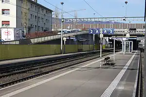 Island platform and side platform with road bridge crossing above