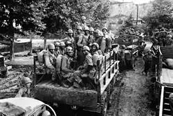 Men in trucks driving down a road