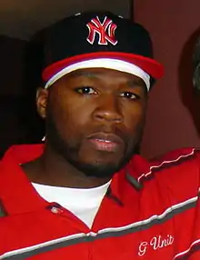 Durags, snapbacks and polo shirts were popular in the 2000s as men's wear, shown here by rapper 50 Cent in 2006