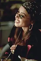 Bandanas, large hoop earrings and wireframe rectangle sunglasses were fashion trends in the early-2000s, as modeled here by R&B artist Aaliyah in 2000