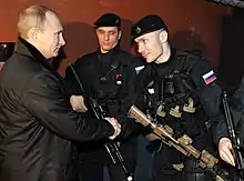 Member of Alpha Group, Russian Federal Security Service (right) shown with an AK-105 fitted with a LA-5/PEQ to the top of hand guard.