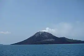 Aerial view of volcanic island with another, rocky island in the background