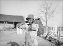 Annie Pettway Bendolph carrying water. Gee's Bend, Alabama. April 1937. Photographed by Arthur Rothstein.