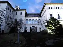 Gate and white hospital building