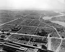 A neighboorhood in ruin after an air raid in 1944. Several emblematic buildings are shown in ruin