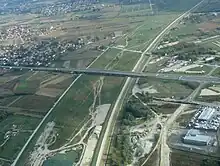 Aerial view of a large, mostly dry and grassy canal