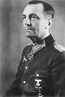 Black-and-white portrait of a man in semi profile wearing a military uniform with an Iron Cross displayed at his neck.