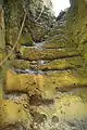 Ascent to the ruins on the southern spur through a small cave with steps hewn out of the rock