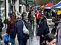 A view in St Albans Market along St Peter’s Street showing shoppers in the rain.