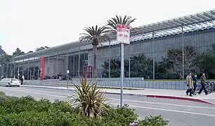 Overhead solar cells shade the entry facade