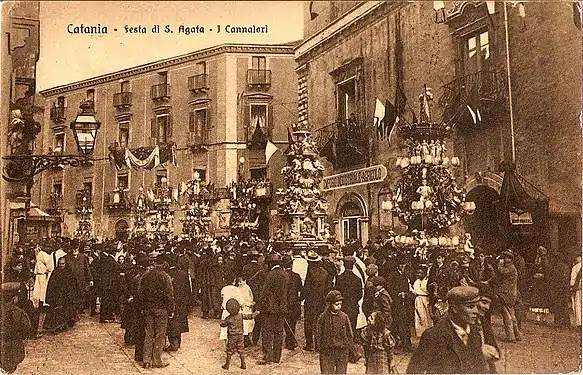 A sepia-toned black and white photograph of a crowd of people.