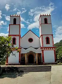 A yellow cathedral with a single spire