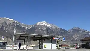 Canopy-covered platform shelter with mountains in the distance