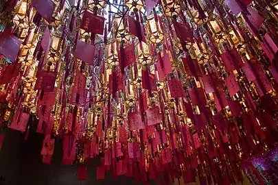 Devotee lanterns; donor names are written on red paper and attached to the lanterns