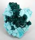 Dioptase on Chrysocolla,  Otjikotu,  Kunene Region, Namibia. 6.8 × 5.5 × 4.5 cm