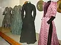 Display of four Victorian dresses.