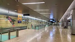 Open concourse with stairs leading to the platform downwards and the mural on the left