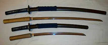 Antique Japanese (samurai) daishō, the traditional pairing of two Japanese swords which were the symbol of the samurai, showing the traditional Japanese sword cases (koshirae) and the difference in size between the katana (top) and the smaller wakizashi/kodachi (bottom).