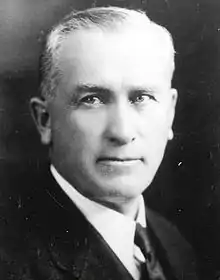 A head-shot of a white-haired man