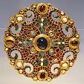 The Dorestad Brooch, c. 800, found in the Netherlands. Gold, pearls, with cloisonné almandine, enamel, and glass.