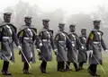 Filipino Cadets Marching in the Rain Wearing greatcoats.