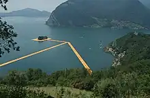 View from Montisola of The Floating Piers and the San Paolo isle in the middle, Gallinarga (Tavernola Bergamasca, province of Bergamo) in the left side of the background, and Clusane (Iseo, BS) in the right side of the background, 2016