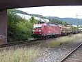 A freight train hauled by an Traxx (class 185) locomotive passes through Wurmlingen Nord station