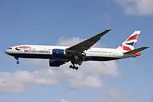 Aircraft landing approach. Side view of a twin-engine jet in flight with flaps and landing gear extended.