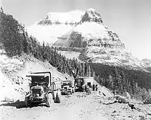 Road construction along the Going-to-the-Sun Road with Going to the Sun Mountain in background, 1932