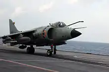 Jet aircraft on deck of aircraft carrier. Its refuelling receptacle is extended near the pilot's canopy