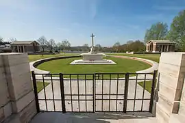 Hooge Crater Cemetery entrance with Cross of Sacrifice and the stone-faced circle designed by Sir Edwin Lutyens in memory of the many craters nearby