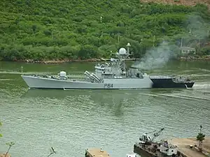 Navy vessel sailing through canal