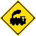 Traffic signs often use silhouettes. This sign warns that the road crosses a railway line.