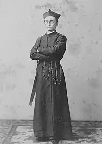 Photograph of Richards standing with arms crossed