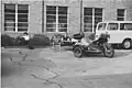 Left to right on the couch: Eric Bussen, Steve Hendren, Matt Koebbe behind his motorcycle with sidecar outside old T-6 KMNR.  On the chair is Sylvia Carty (not yet Carty at this point). It was a beautiful Spring day, and they had to pull the furniture out to enjoy the day.