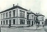 Photo of a larger, more contemporary building, with two stories and large windows