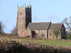 Reddish building with square tower.