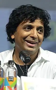 Shyamalan smiling