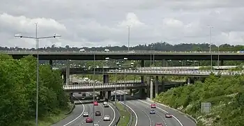 Image 34The multi-level junction between the M23 and M25 motorways near Merstham in Surrey. The M23 passes over the M25 with bridges carrying interchange slip roads for the two motorways in between.