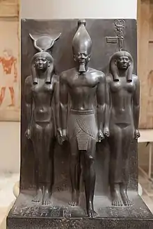 Statue of Menkaure with Hathor and Cynopolis; 2551–2523 BC; schist; height: 95.5 cm; Egyptian Museum (Cairo). Demonstrates a group statue with Old Kingdom features and proportions.