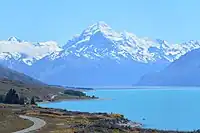 A large mountain with a lake in the foreground