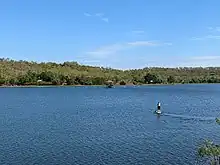 Woman on stand-up paddle-board on Lake Bennett