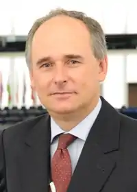 Professional headshot of Paweł Zalewski in a suit.