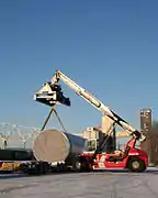 Project cargo is loaded onto a trailer by a reach stacker