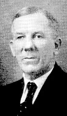 Black and white portrait of a man wearing a suit and tie