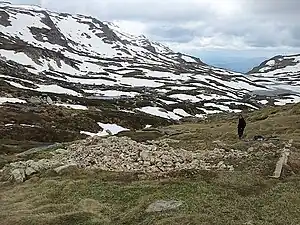 A skier assessing the ruins of Albina Ski Lodge, November 2011.