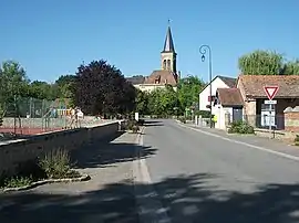 View of Saint-Aubin-le-Monial from Rue des Écoles, and the Saint-Barnabé church in the second ground.